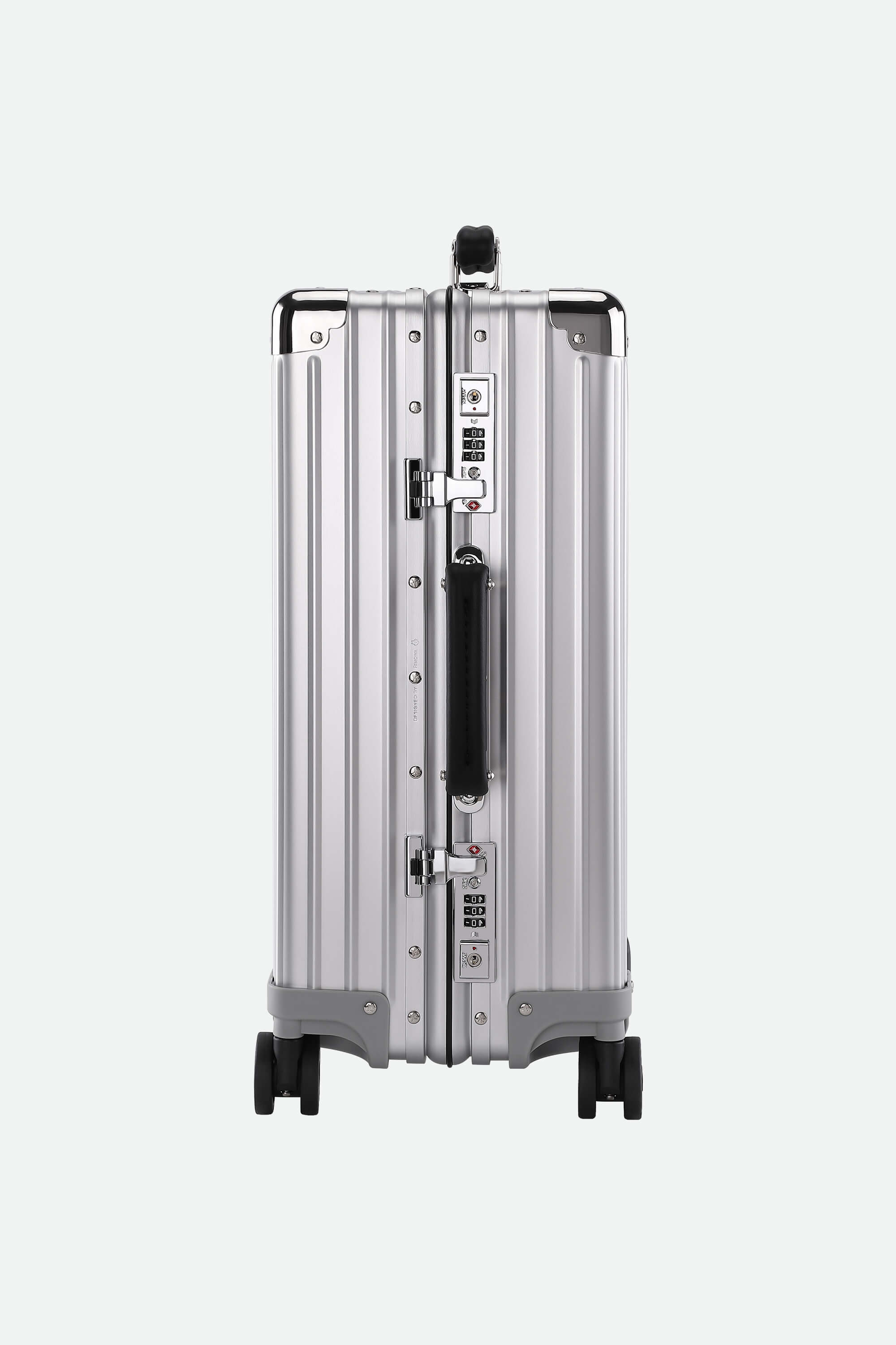 Silver suitcase with black wheels on a white background