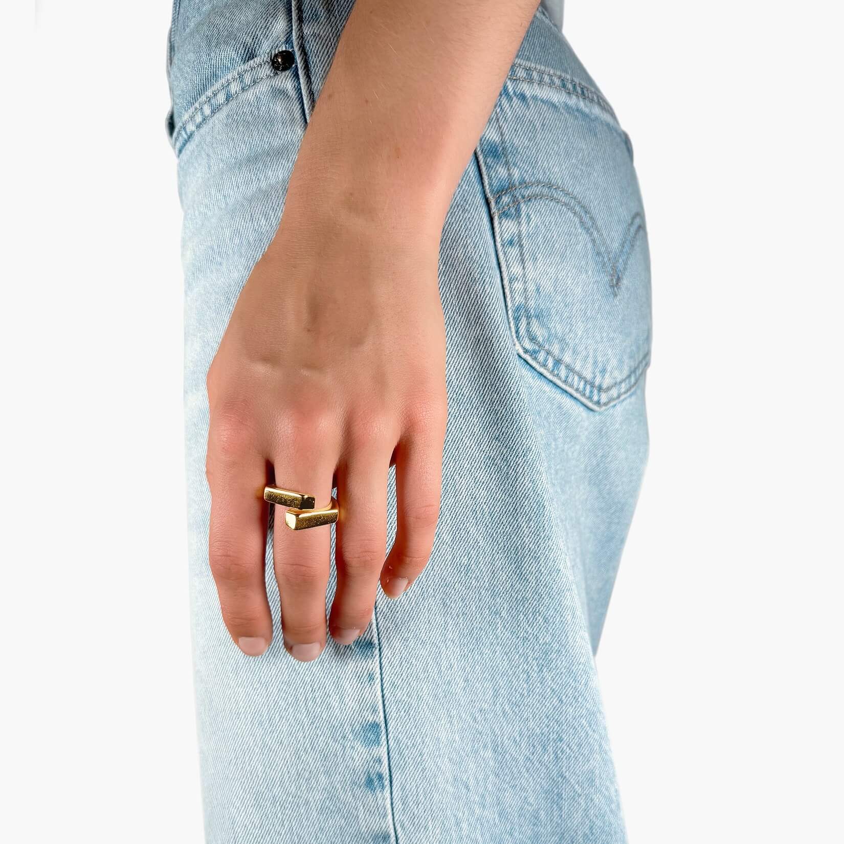 Model wearing Overlapping band ring gold