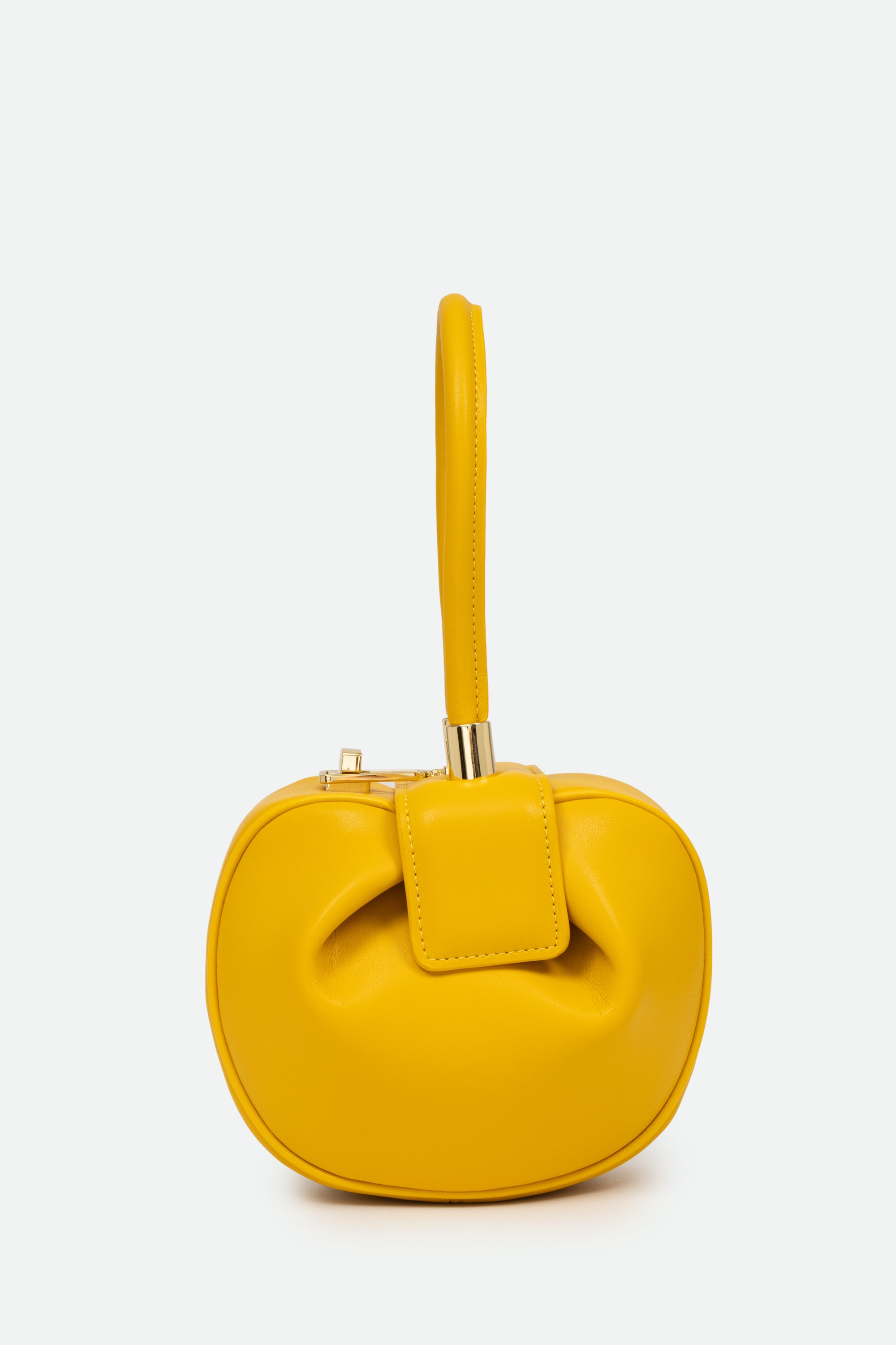 Yellow handbag with a bow detail on a white background