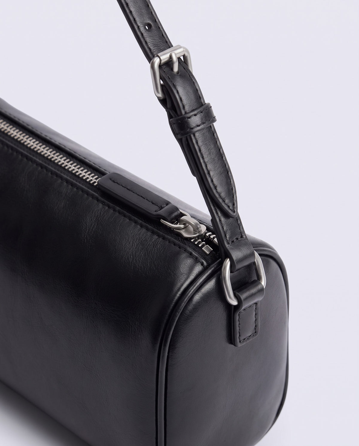 Alba barrel shoulder bag in Black leather – silver buckle and zip hardware detail