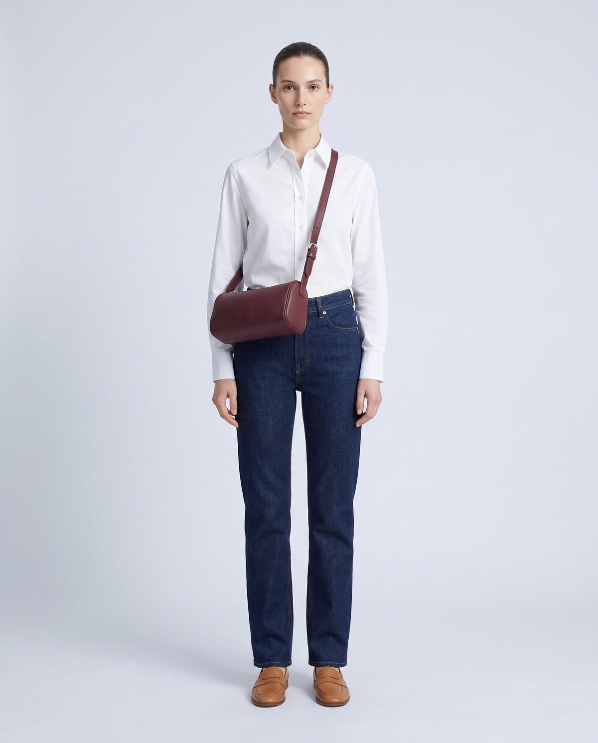 Model wearing the Alba barrel bag in Burgundy leather crossbody – full length