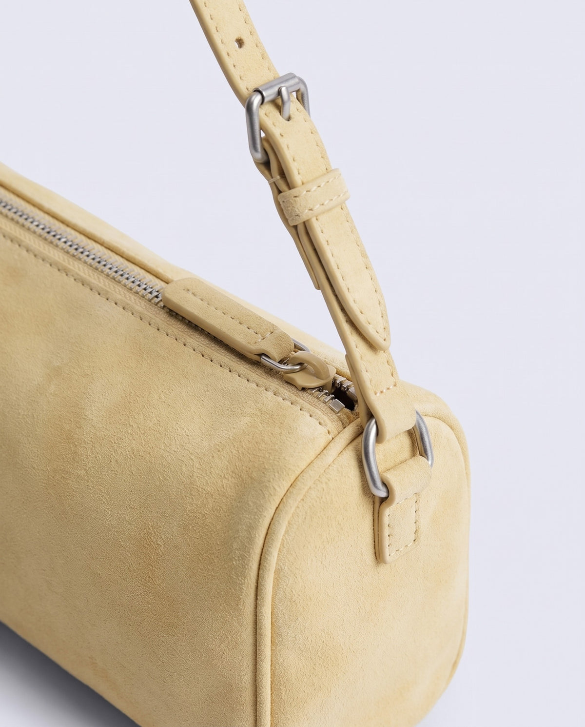 Alba barrel shoulder bag in Butter suede – strap buckle and zip hardware detail