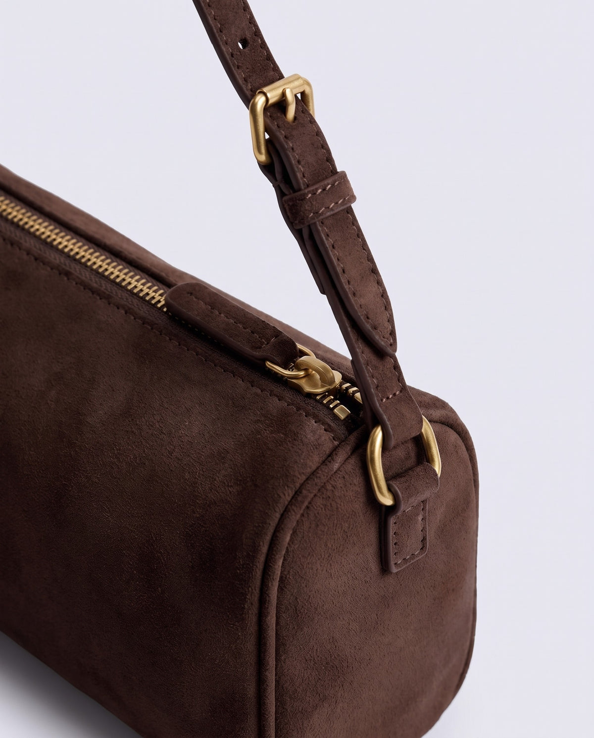 Alba barrel shoulder bag in Espresso suede – gold buckle and zip hardware detail