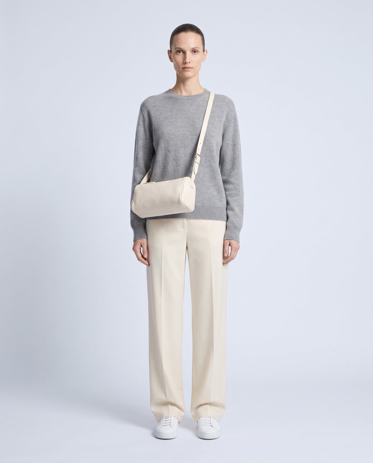 Model wearing the Alba barrel bag in Ivory leather crossbody – full length