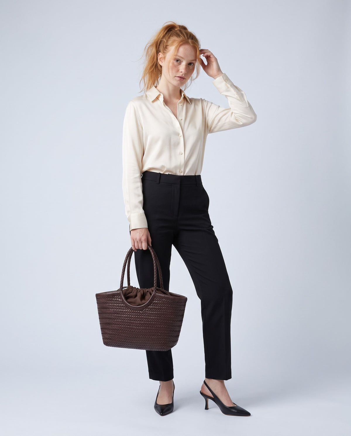 Model carrying the Alghero woven leather tote in Chocolate – full length