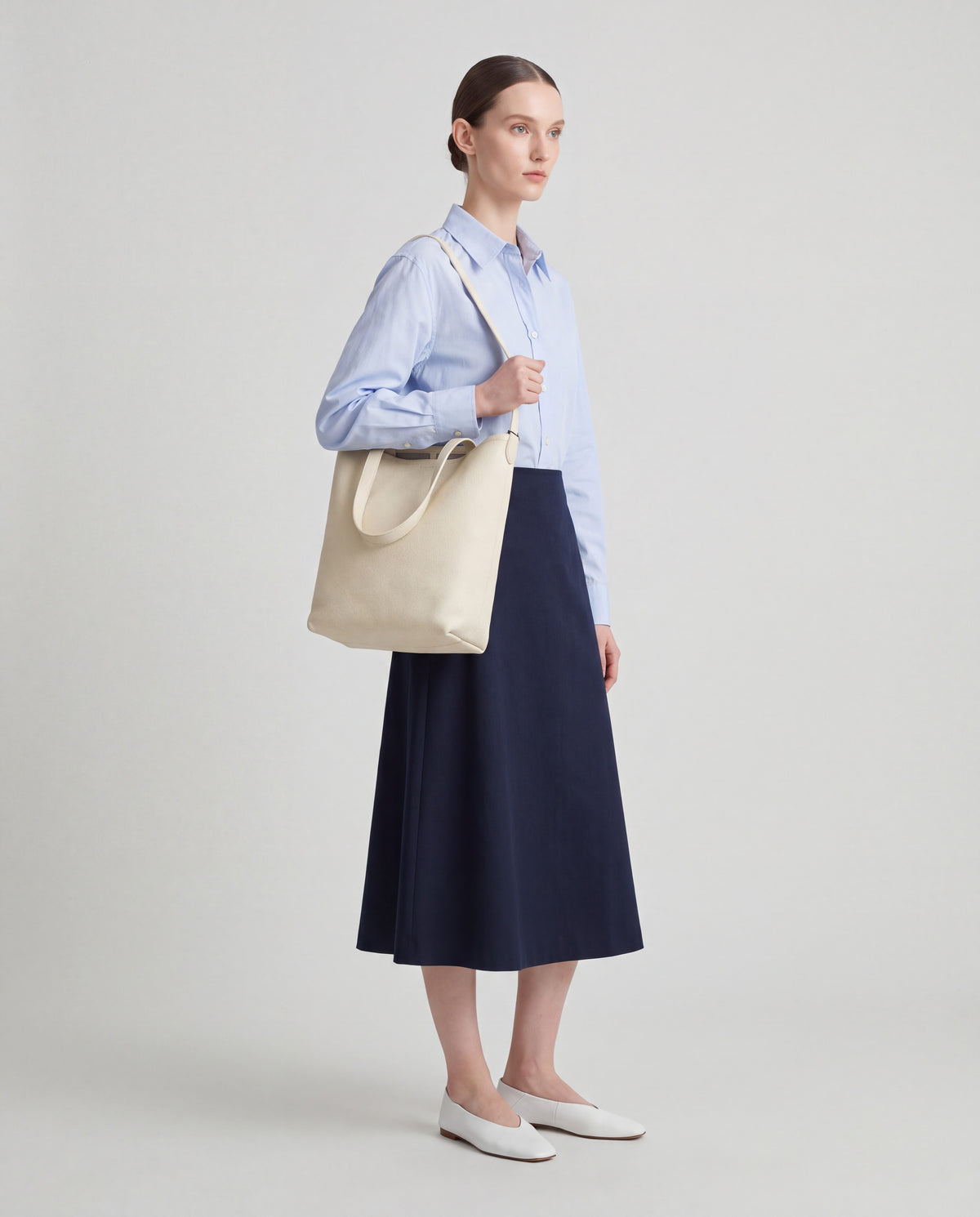 Aria Medium bag in Cream – worn by model, full length
