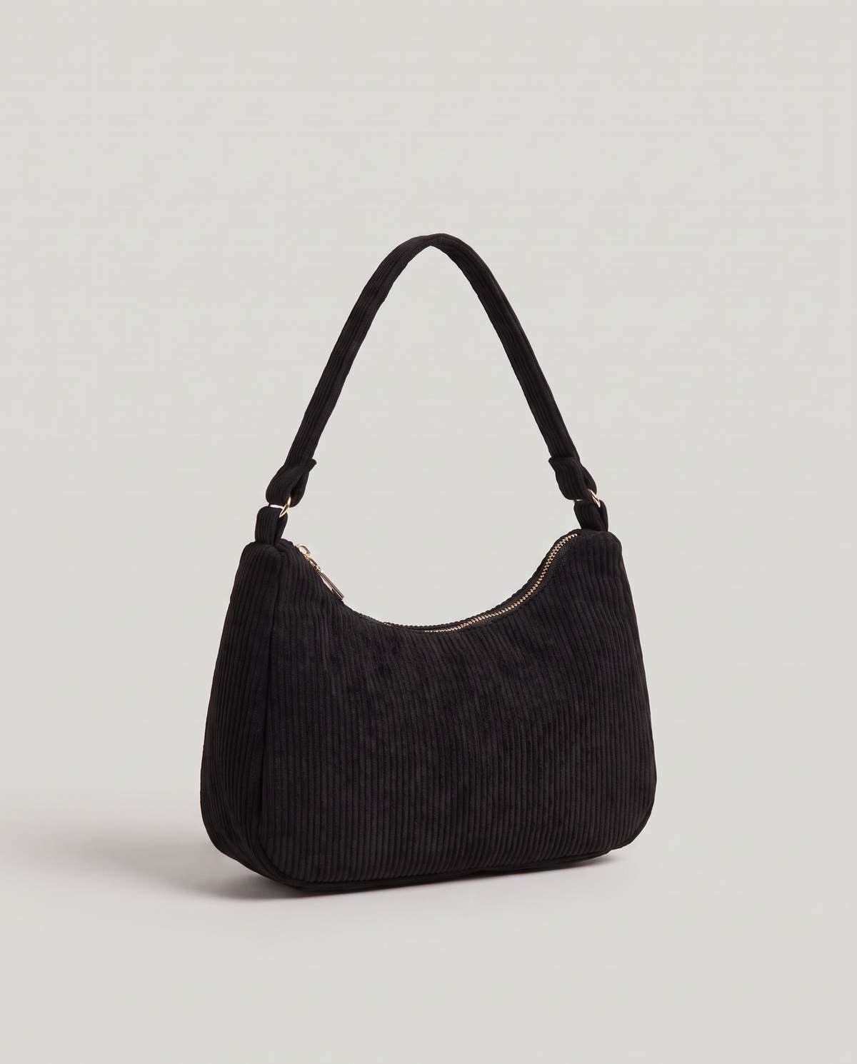 Aura corduroy shoulder bag in Black – three-quarter view