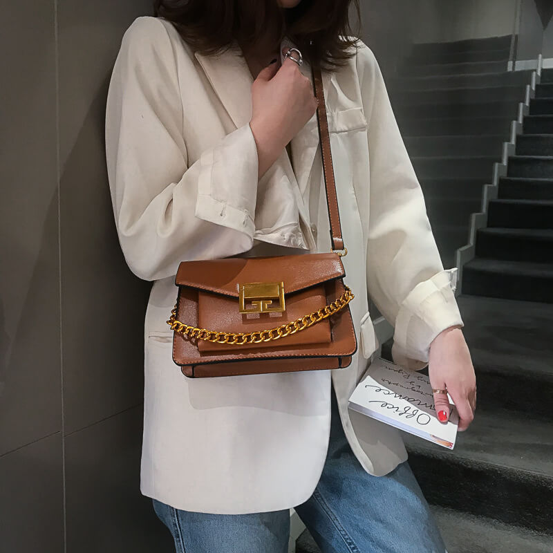 Woman carrying Givenchy gv3 crossbody bag brown