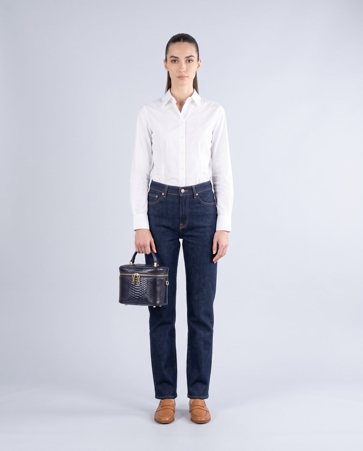 Brindisi snake-embossed vanity bag in Navy – model holding it, full length