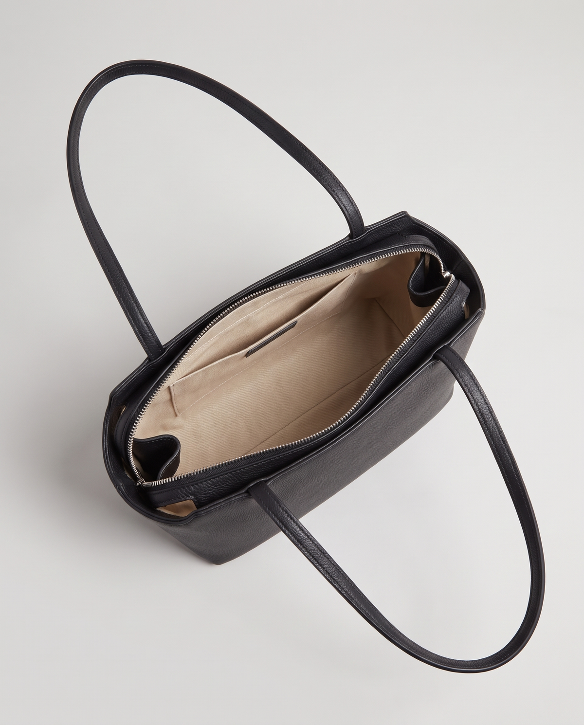 Capri leather shoulder bag in black, open showing interior