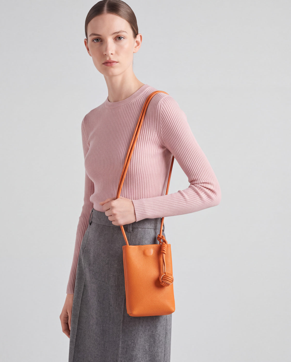 Cara bag in Orange – worn by model, close-up