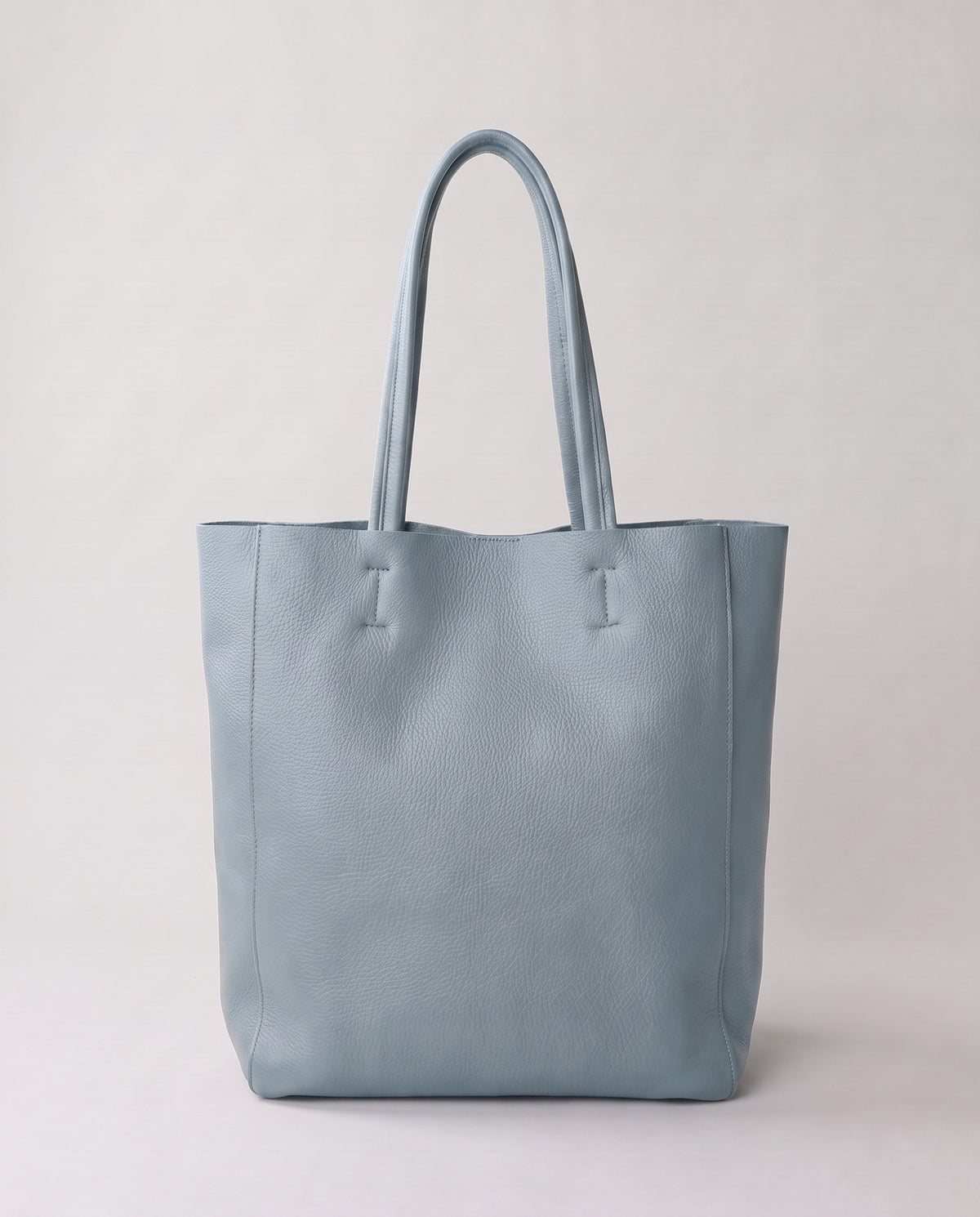 Costa leather tote in blue, back view