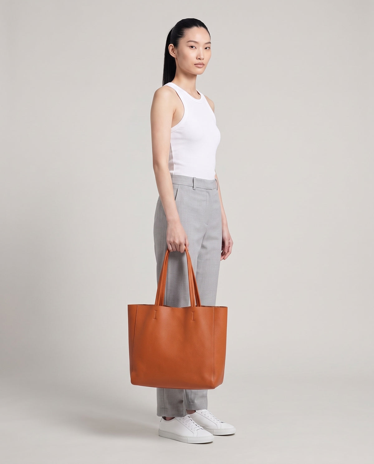 Model with the Costa leather tote in caramel, full length