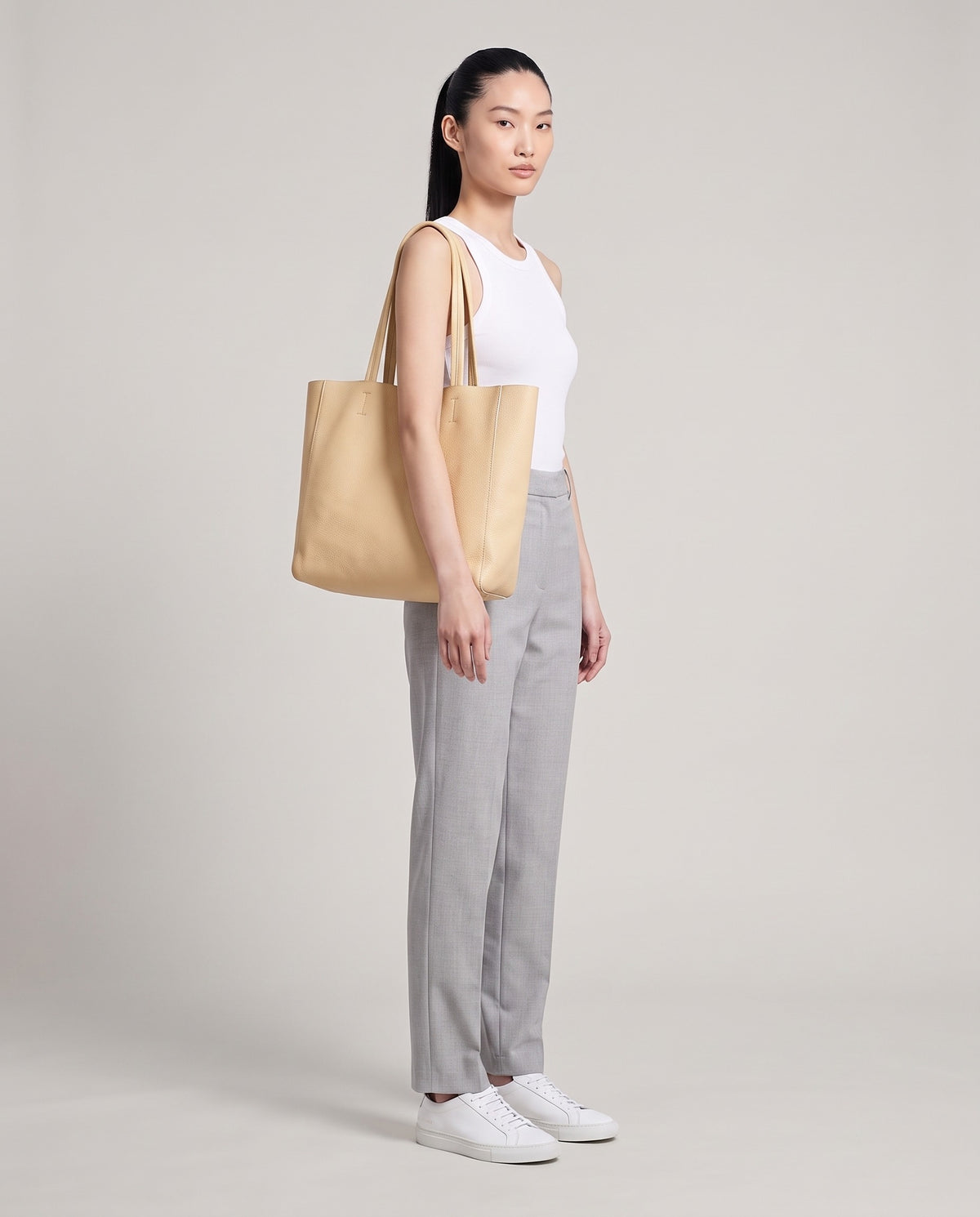 Model with the Costa leather tote in cream, full length