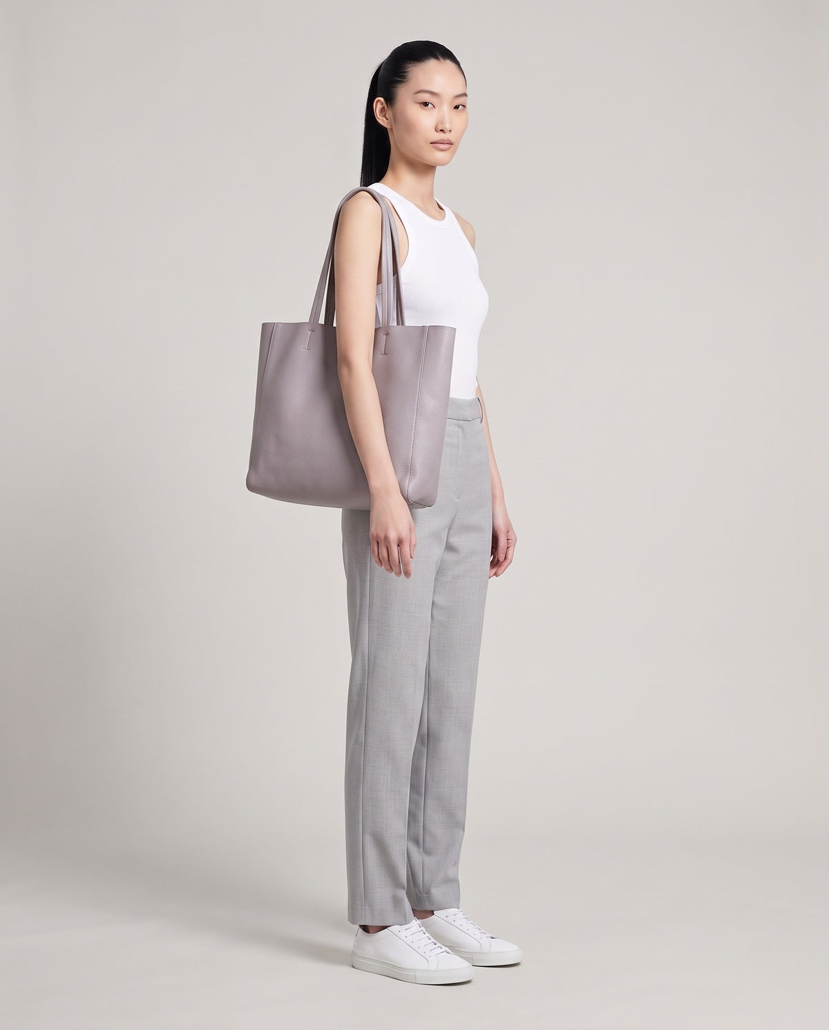 Model with the Costa leather tote in grey, full length