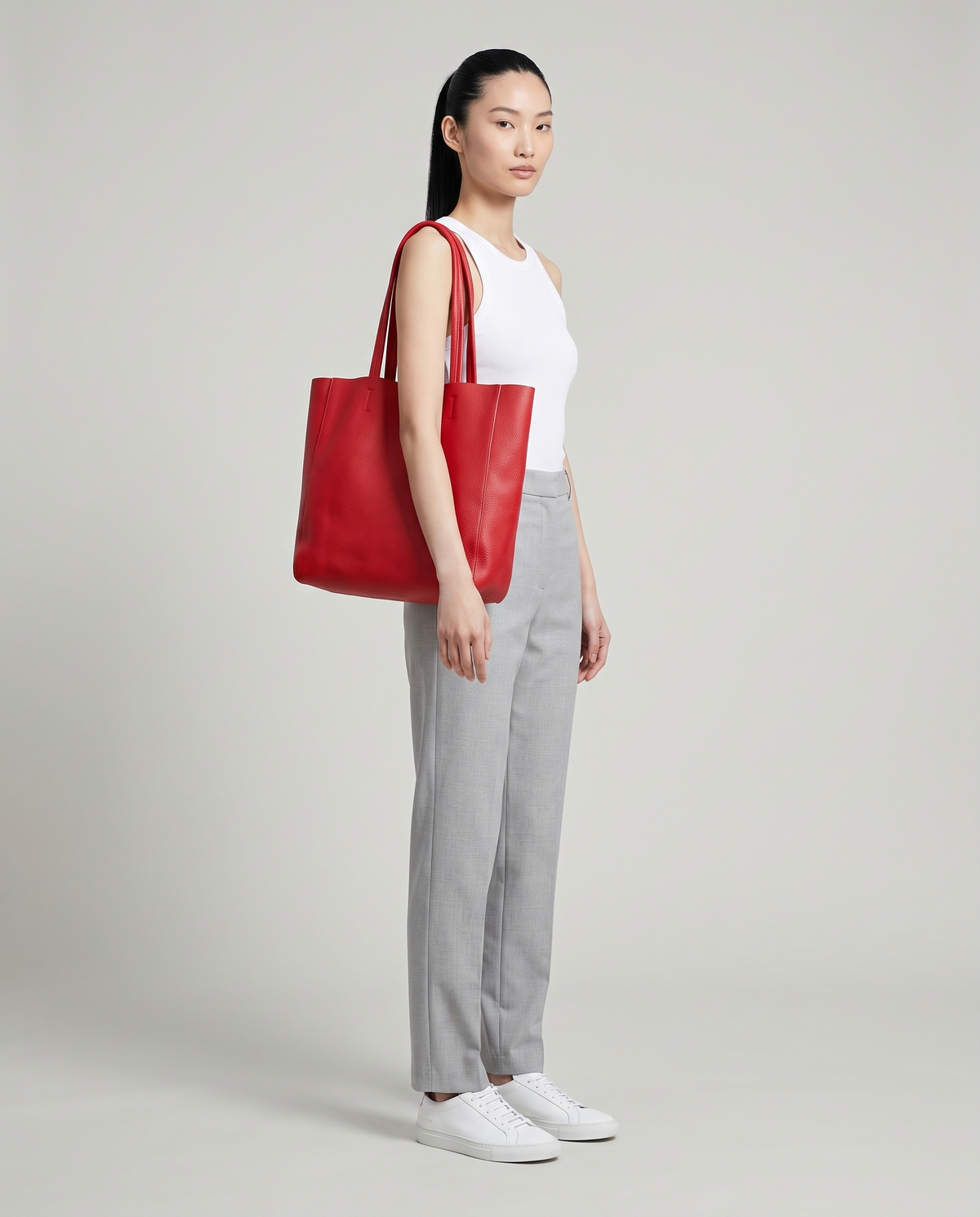 Model with the Costa leather tote in red, full length