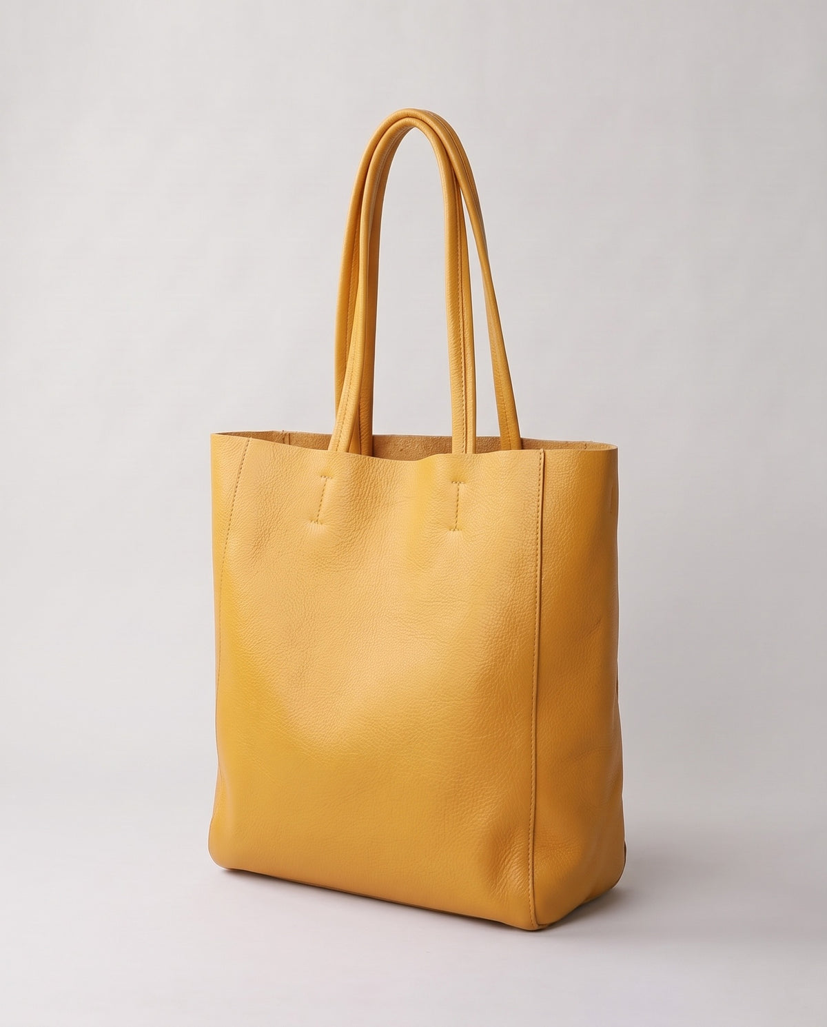 Costa leather tote in yellow, three-quarter view