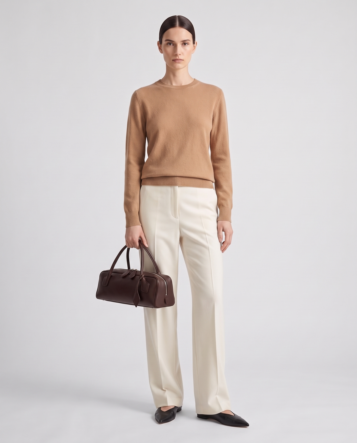 Curve leather barrel bag in Brown – model holding it, full length