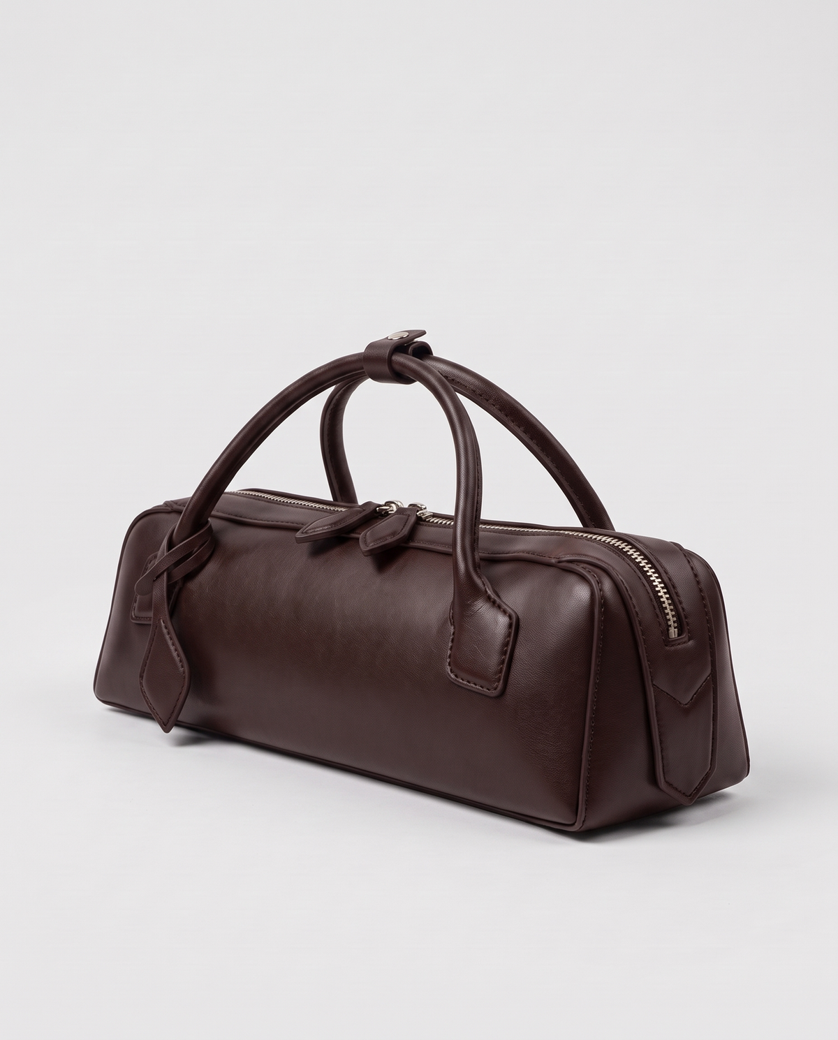 Curve leather barrel bag in Brown – three-quarter view