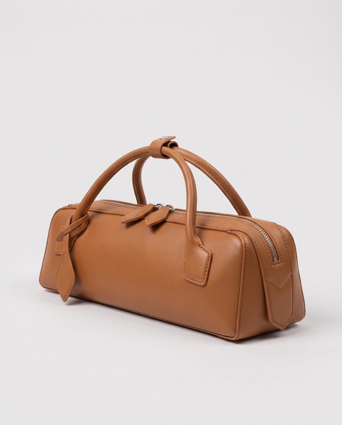 Curve leather barrel bag in Caramel – three-quarter view