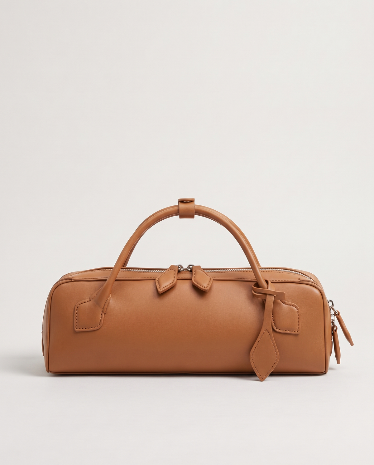 Curve leather barrel bag in Caramel – back view