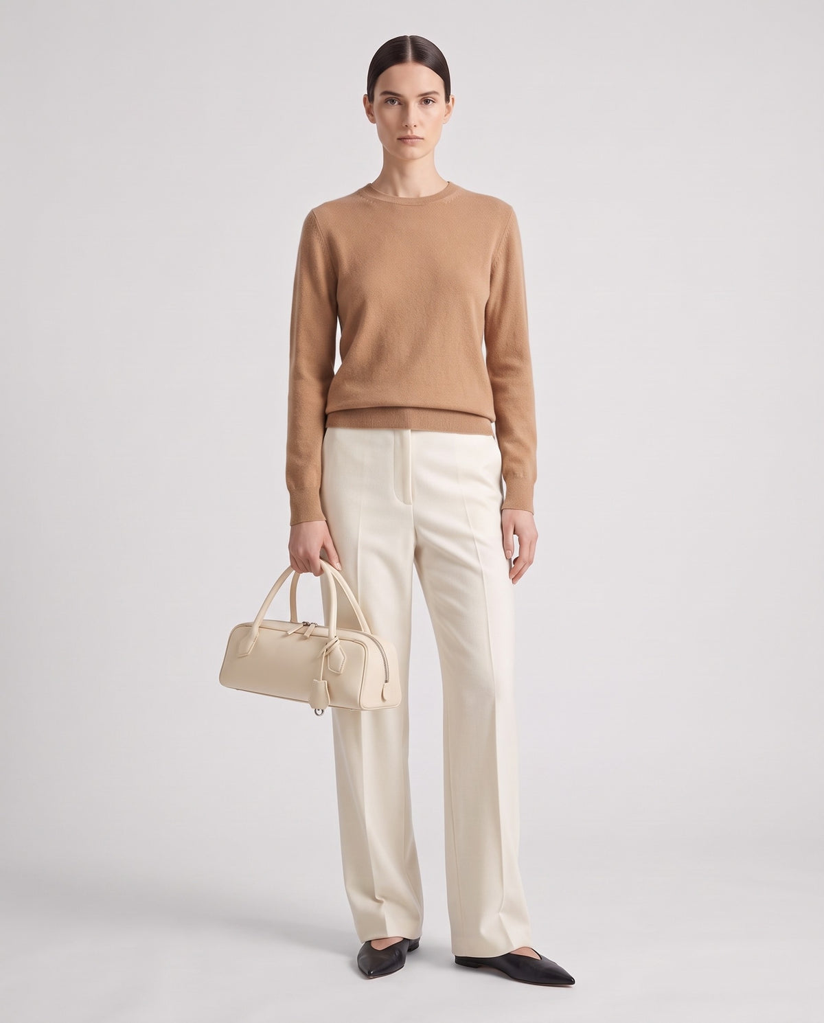 Curve leather barrel bag in Ivory – model holding it, full length