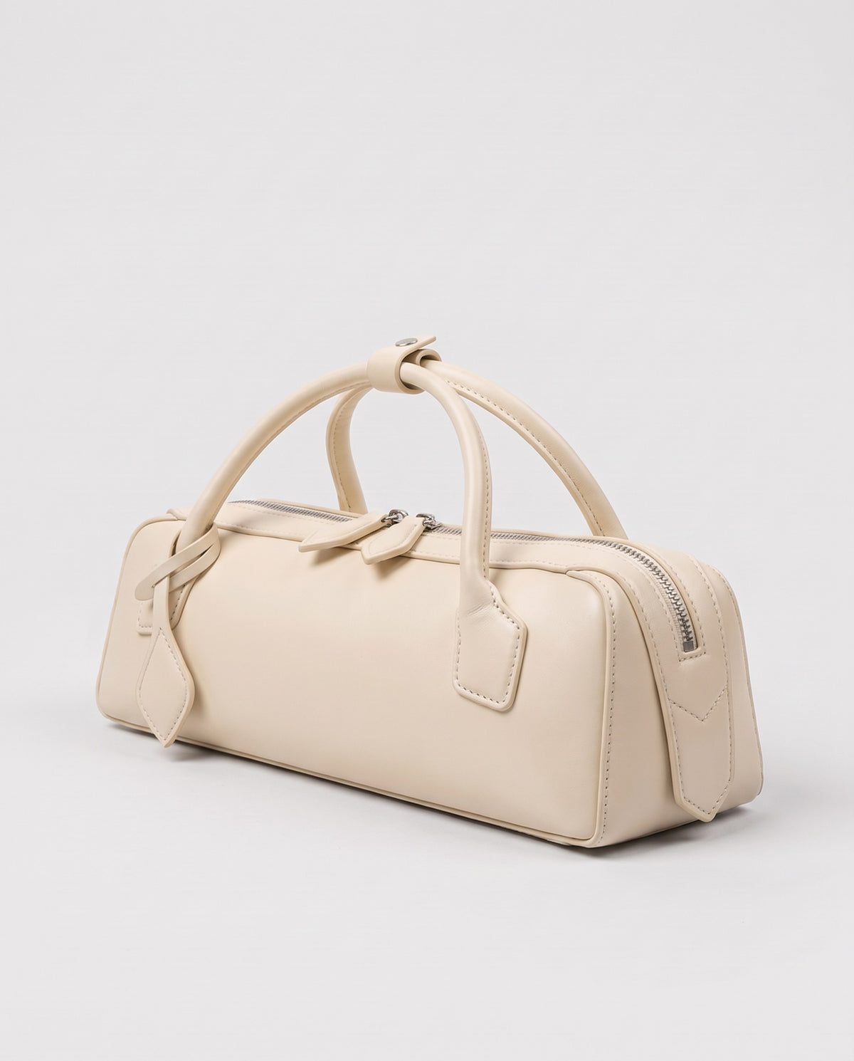 Curve leather barrel bag in Ivory – three-quarter view