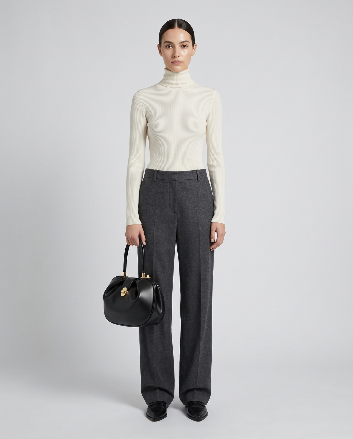 Dumpling Maxi leather top-handle bag in Black – model holding it, full length