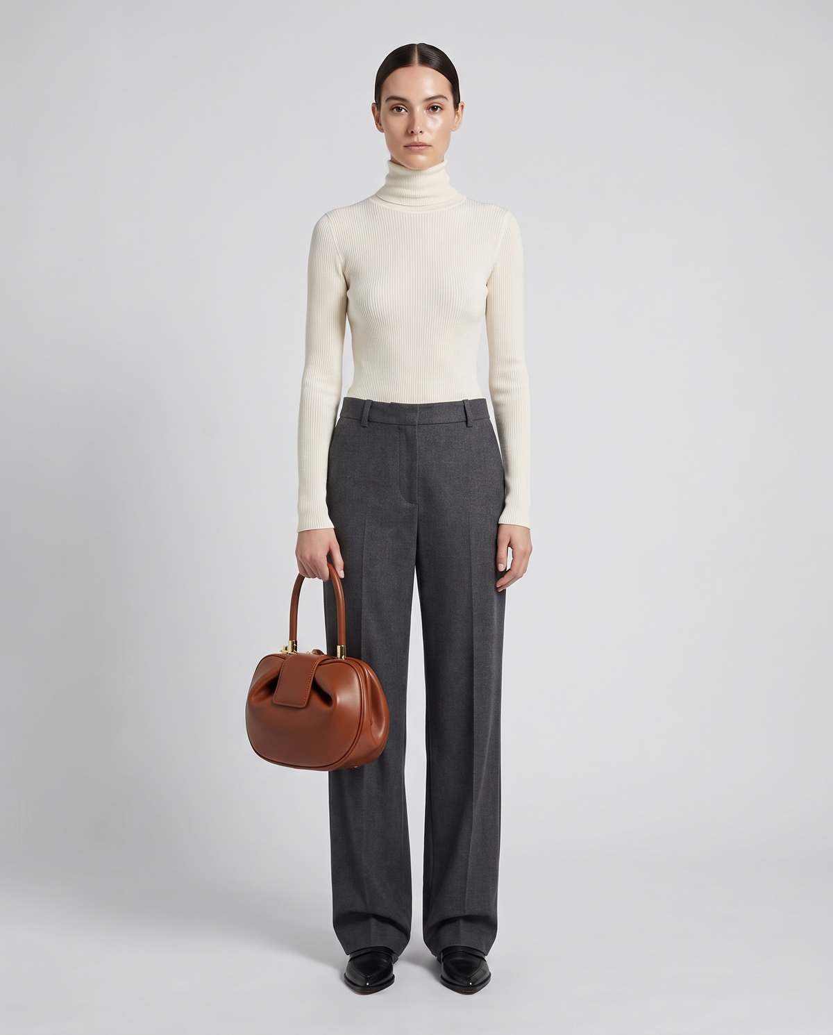 Dumpling Maxi leather top-handle bag in Brown – model holding it, full length