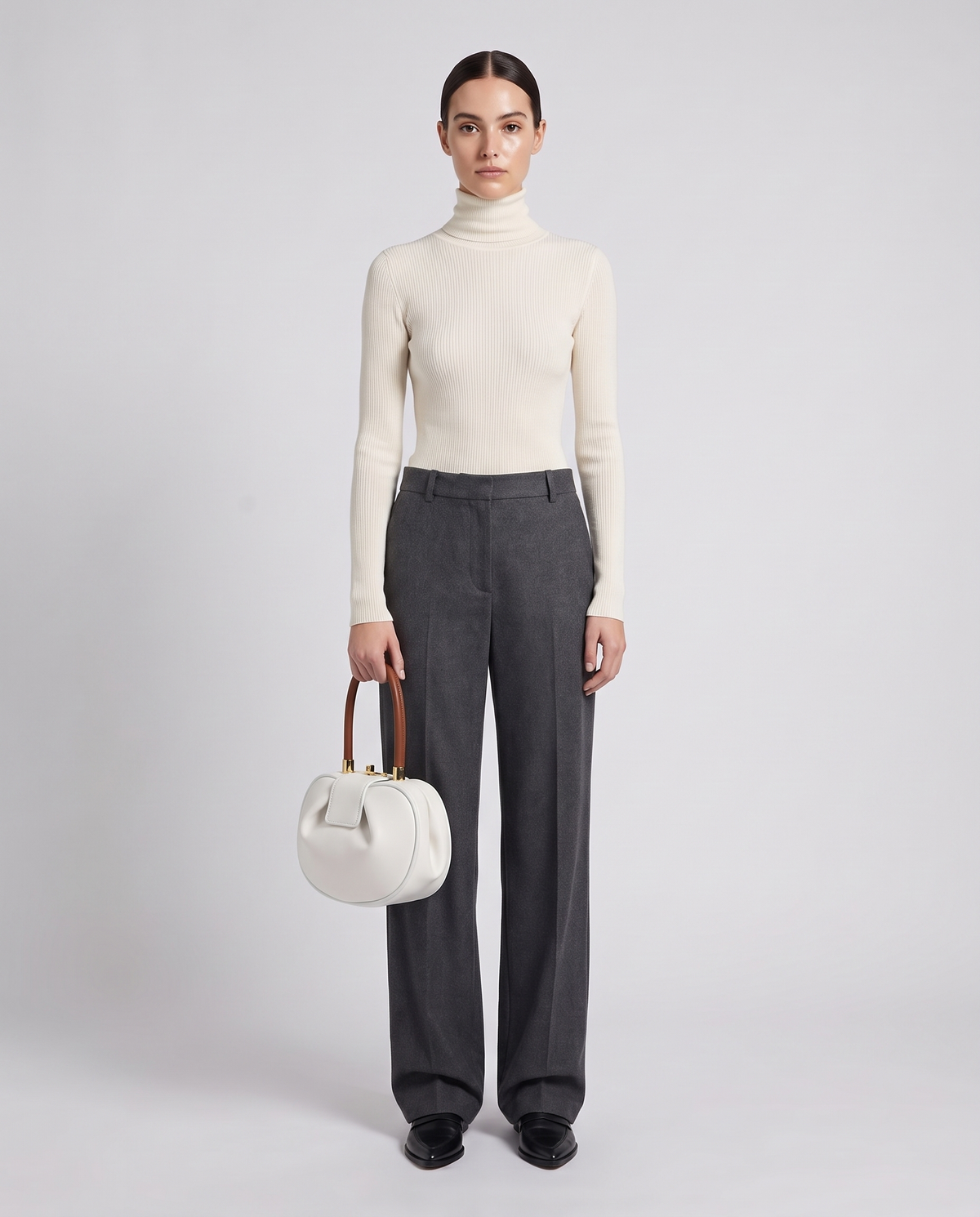 Dumpling Maxi leather top-handle bag in White – model holding it, full length
