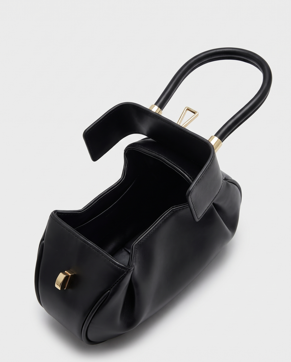 Dumpling Mini leather top-handle bag in Black – open, showing the leather-lined interior