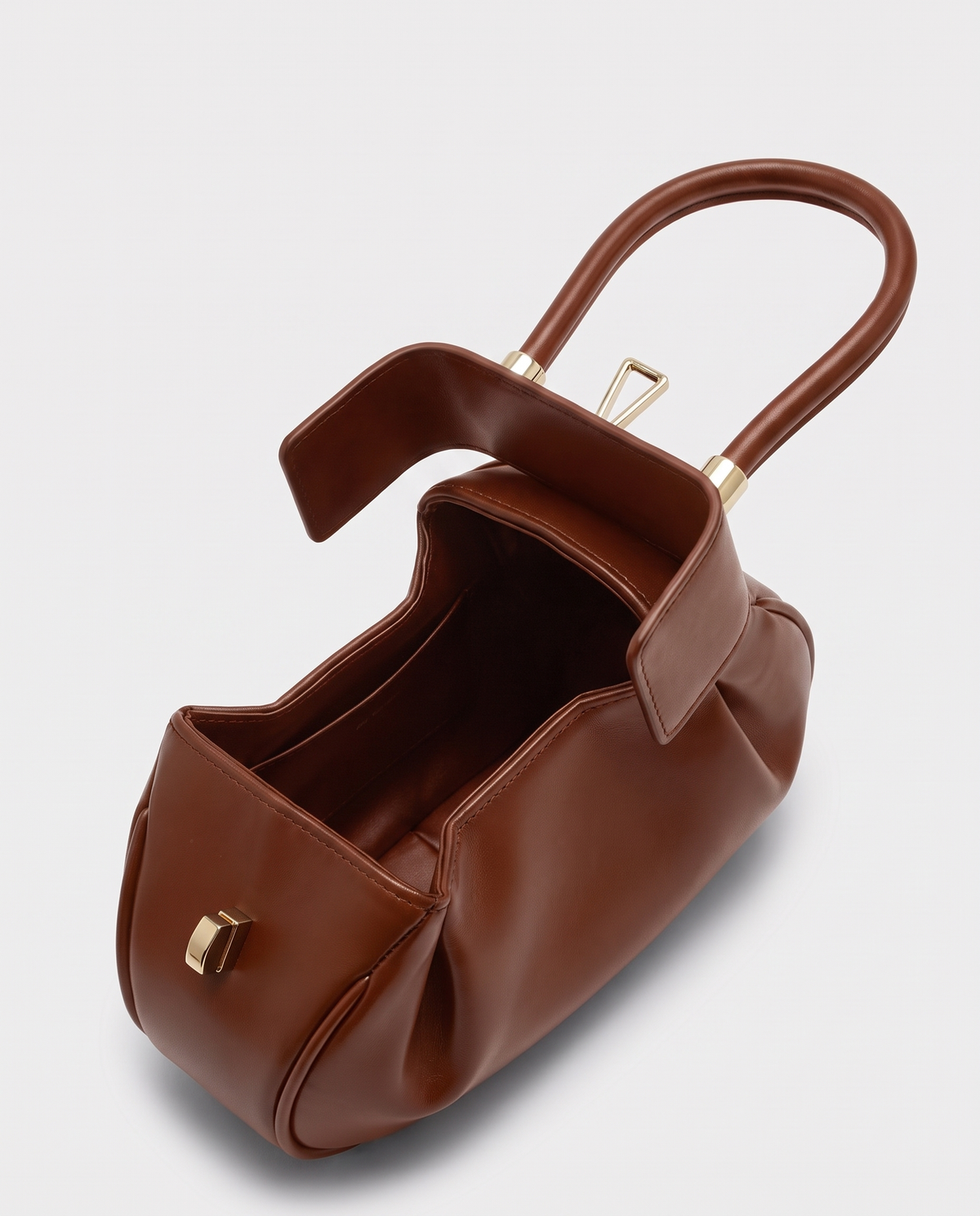 Dumpling Mini leather top-handle bag in Brown – open, showing the leather-lined interior
