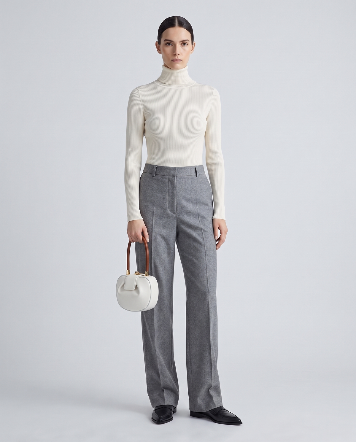Dumpling Mini leather top-handle bag in White – model holding it, full length