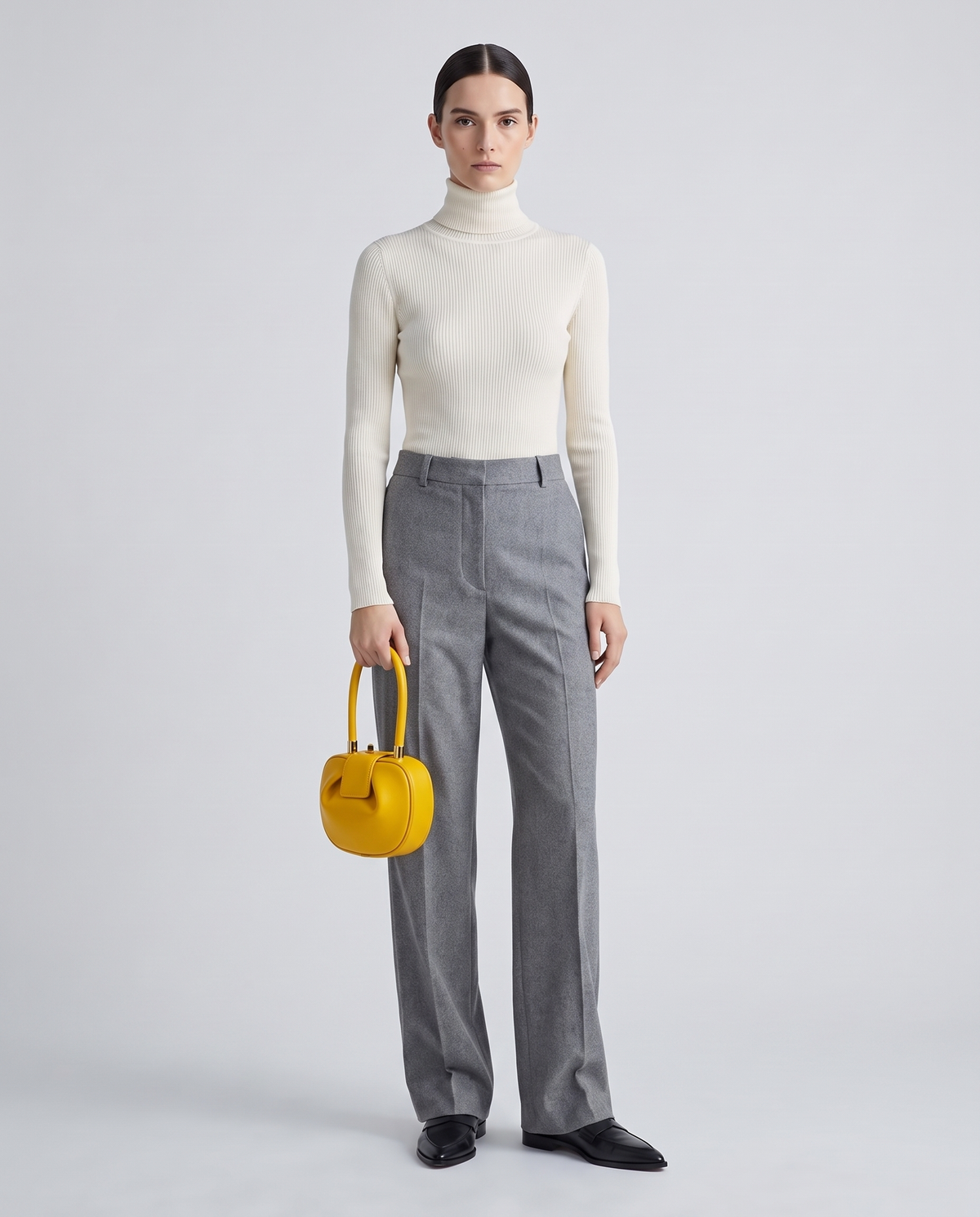 Dumpling Mini leather top-handle bag in Yellow – model holding it, full length