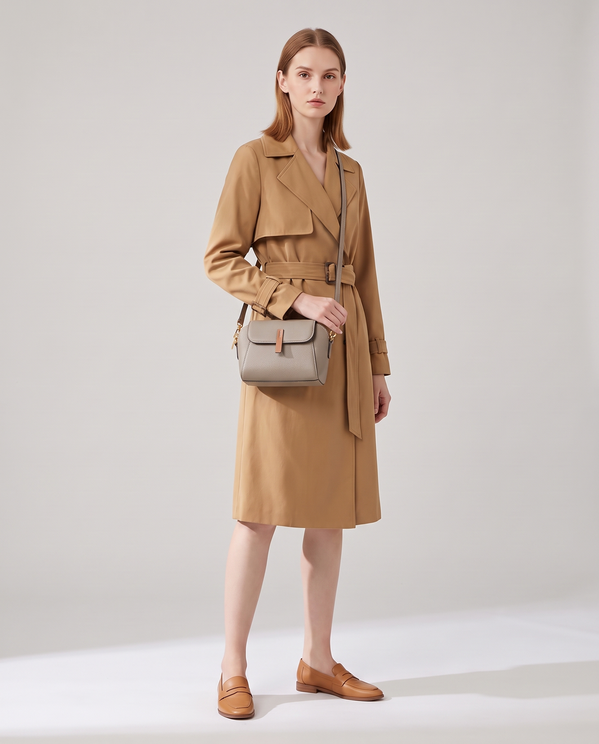 Elara mini leather crossbody in Grey – model wearing it crossbody, full length