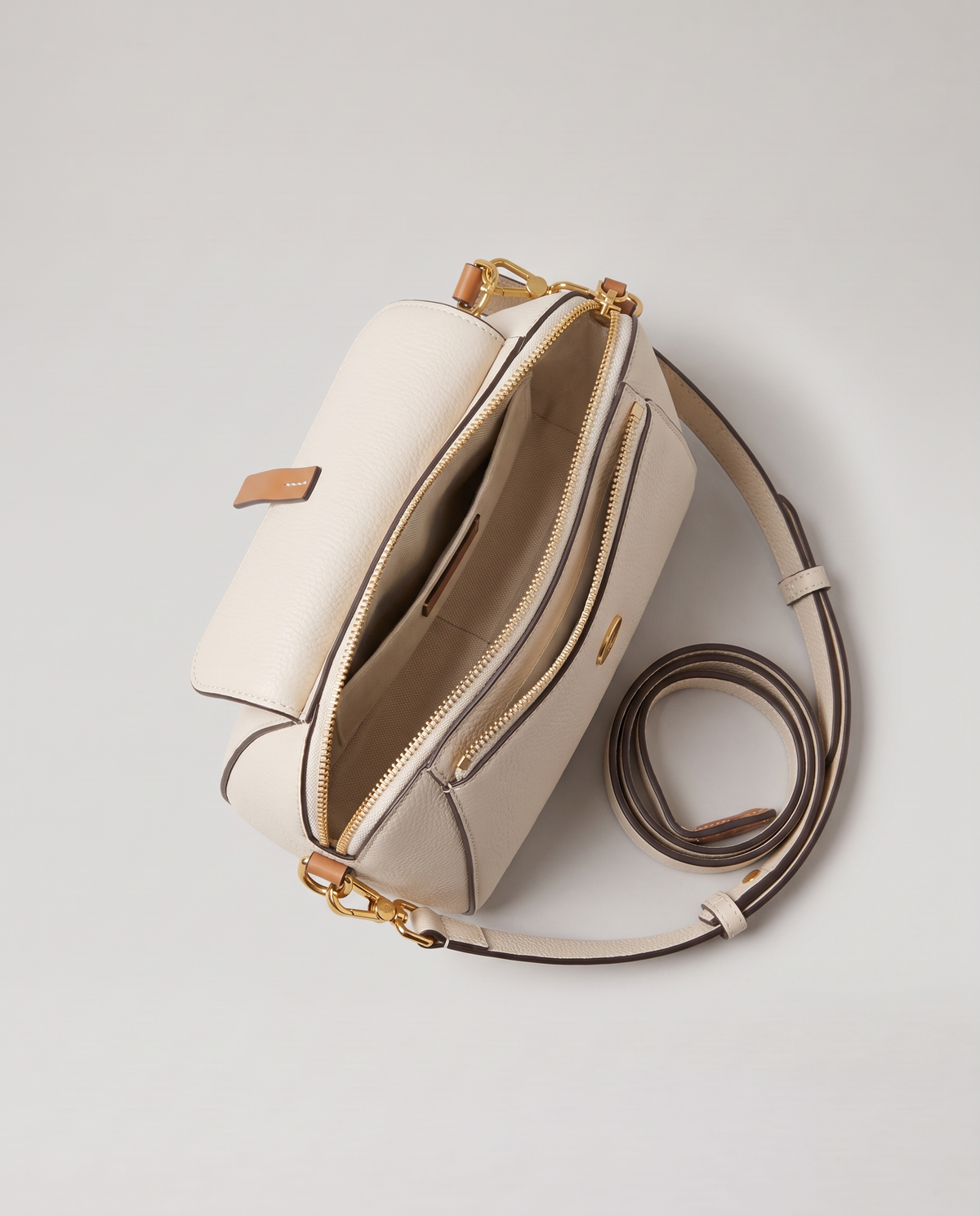 Elara mini leather crossbody in White – open, showing the lined interior