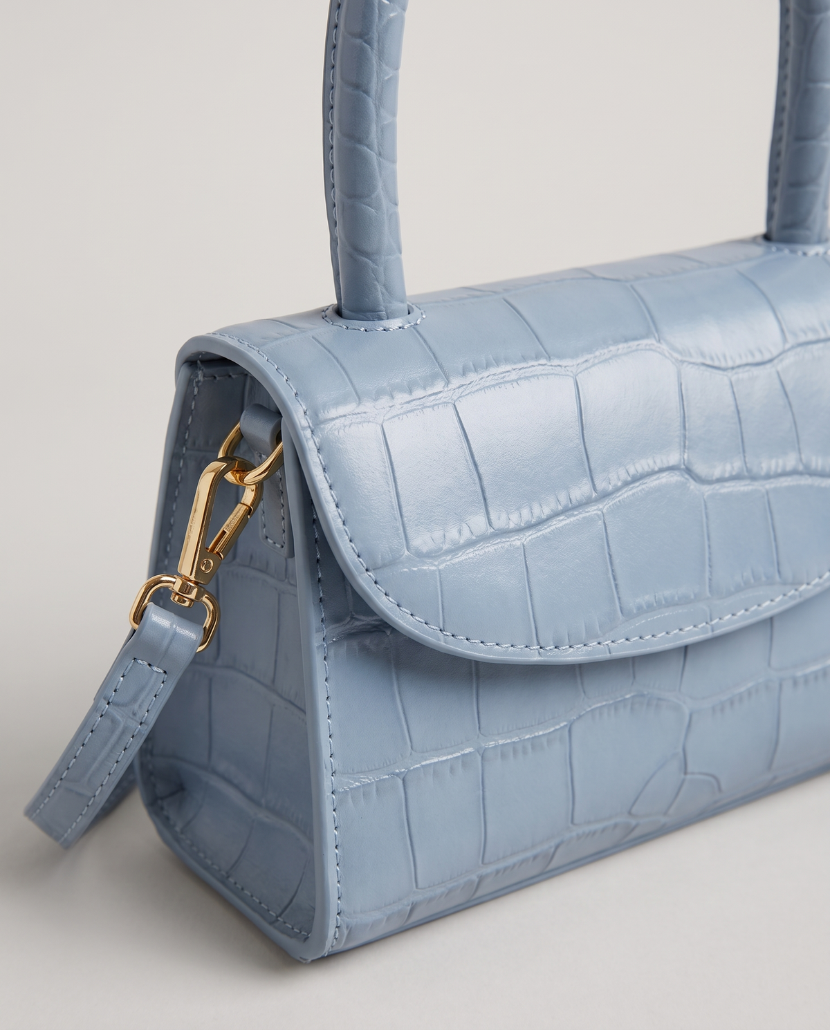Fern mini croc top-handle bag in Blue – close-up of the croc texture and flap