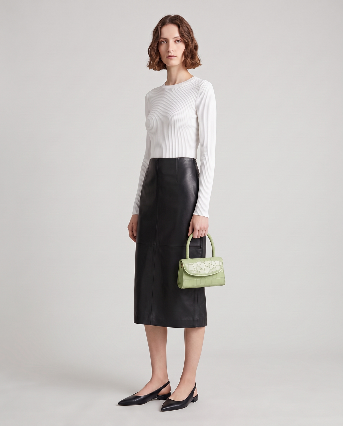 Fern mini croc top-handle bag in Pistachio – model holding it by the top handle, full length