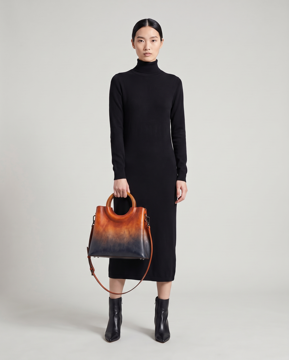 Ombra hand-painted ombré leather bag in Orange – model holding it by the ring handles, full length