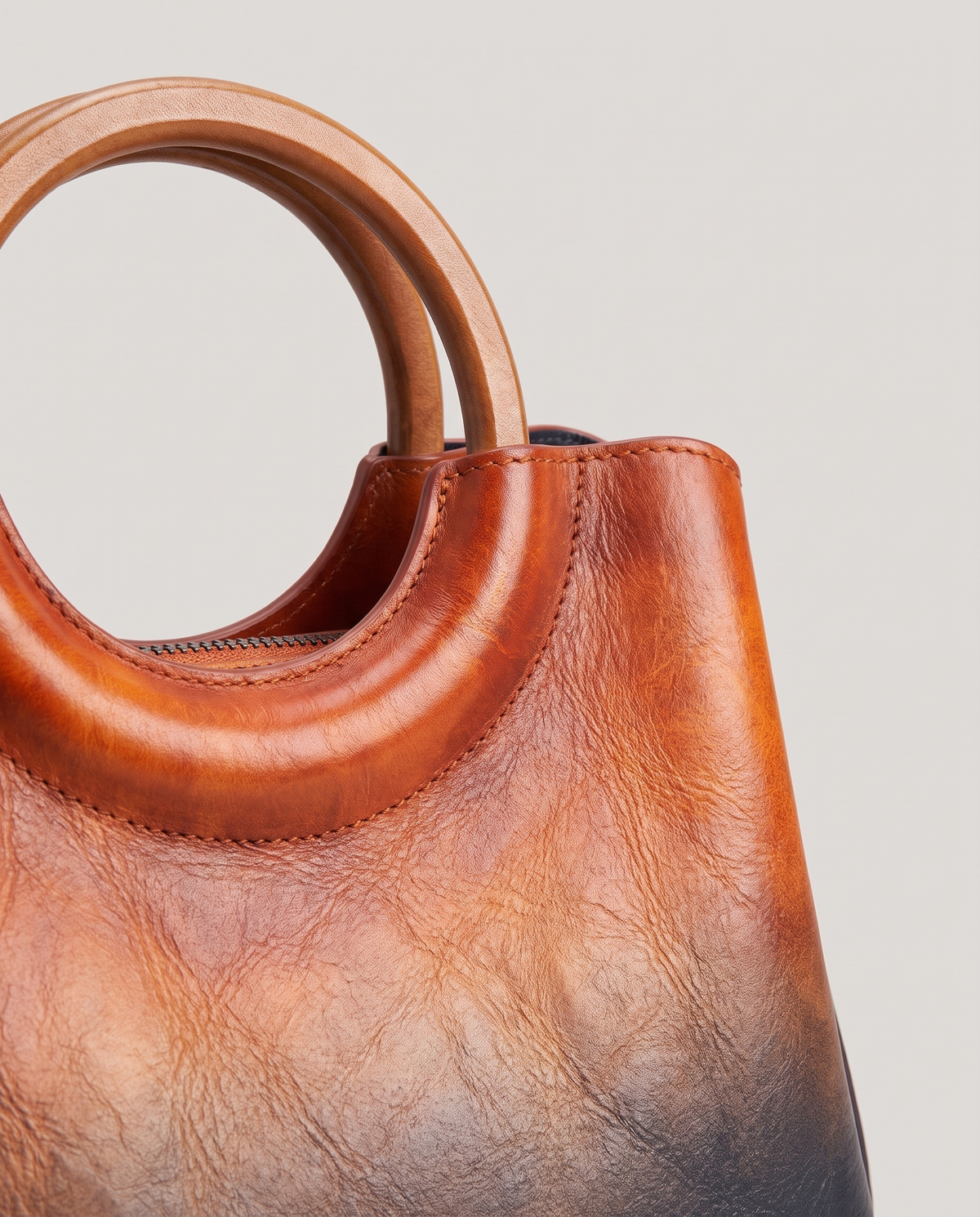 Ombra hand-painted ombré leather bag in Orange – close-up of the ring handle and hand-painted ombré finish