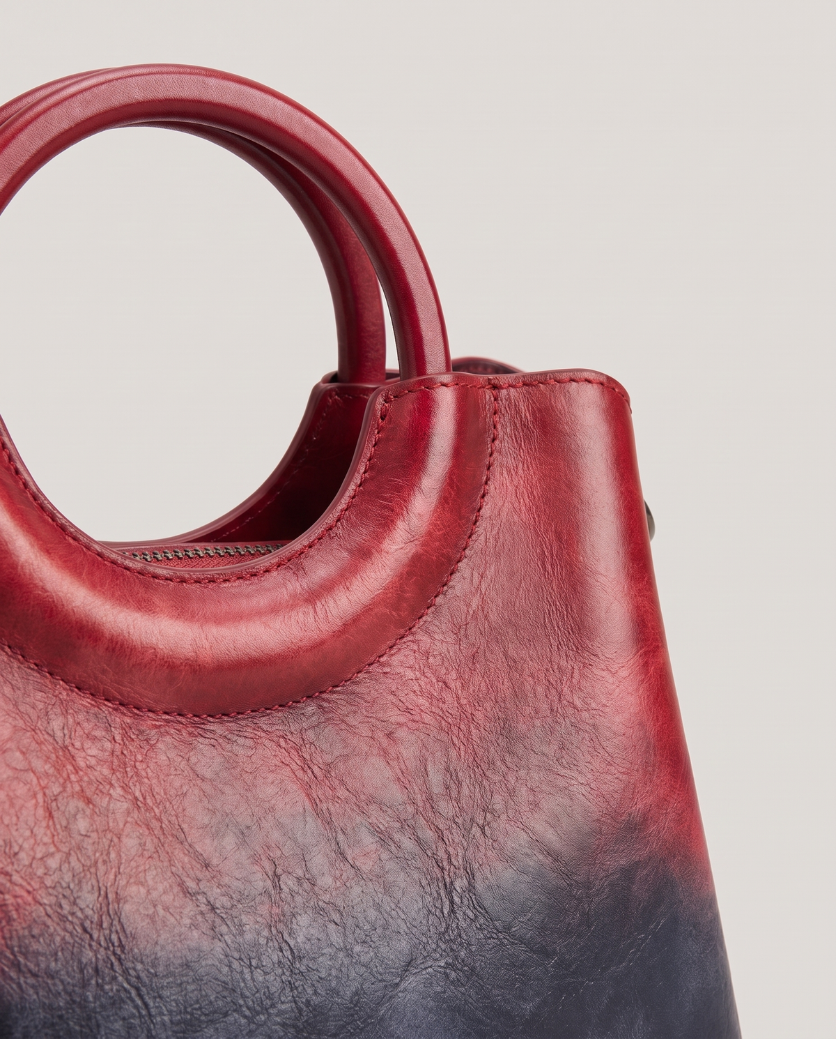 Ombra hand-painted ombré leather bag in Red – close-up of the ring handle and hand-painted ombré finish