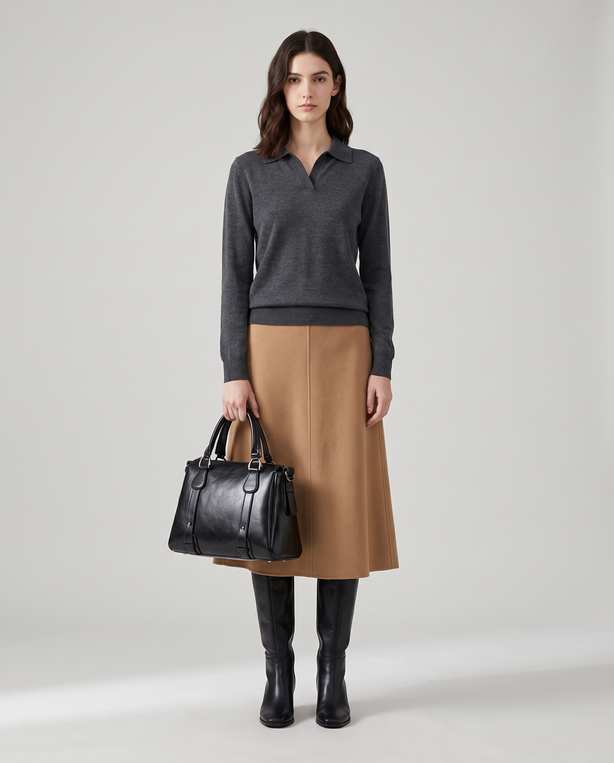 Harlow leather handbag in Black – model holding it by the top handles, full length