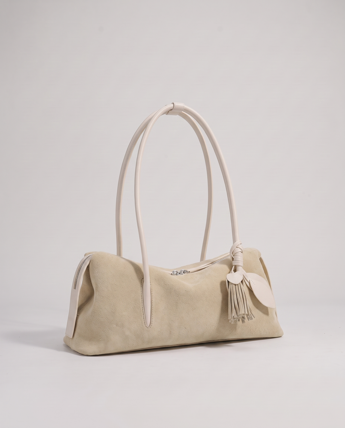 Isola suede shoulder bag in beige, three-quarter view