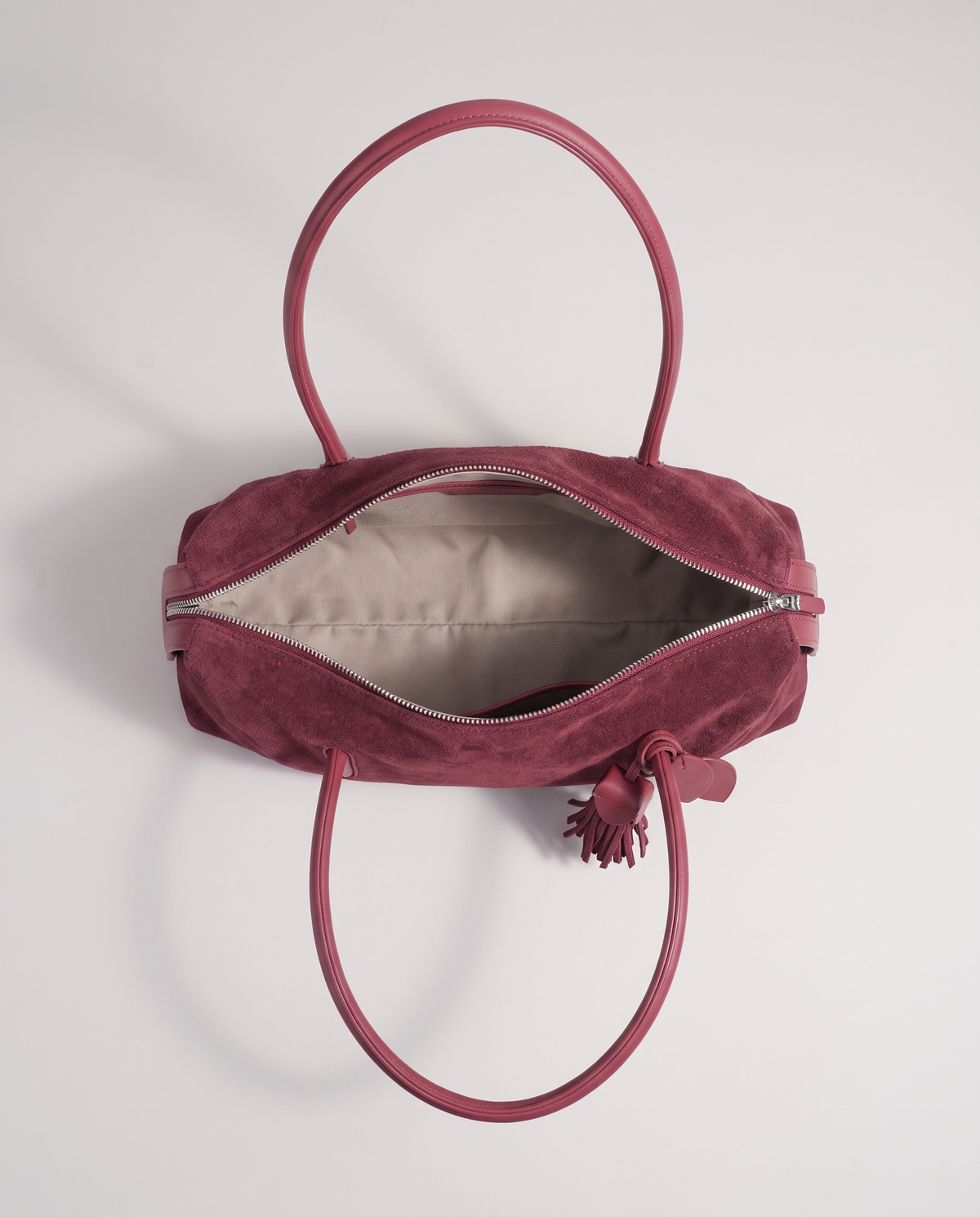 Isola suede shoulder bag in burgundy, open showing interior