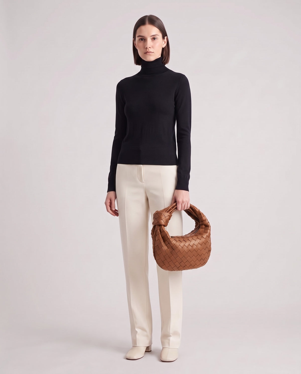 Knot Midi woven leather bag in Brown – model holding it, full length