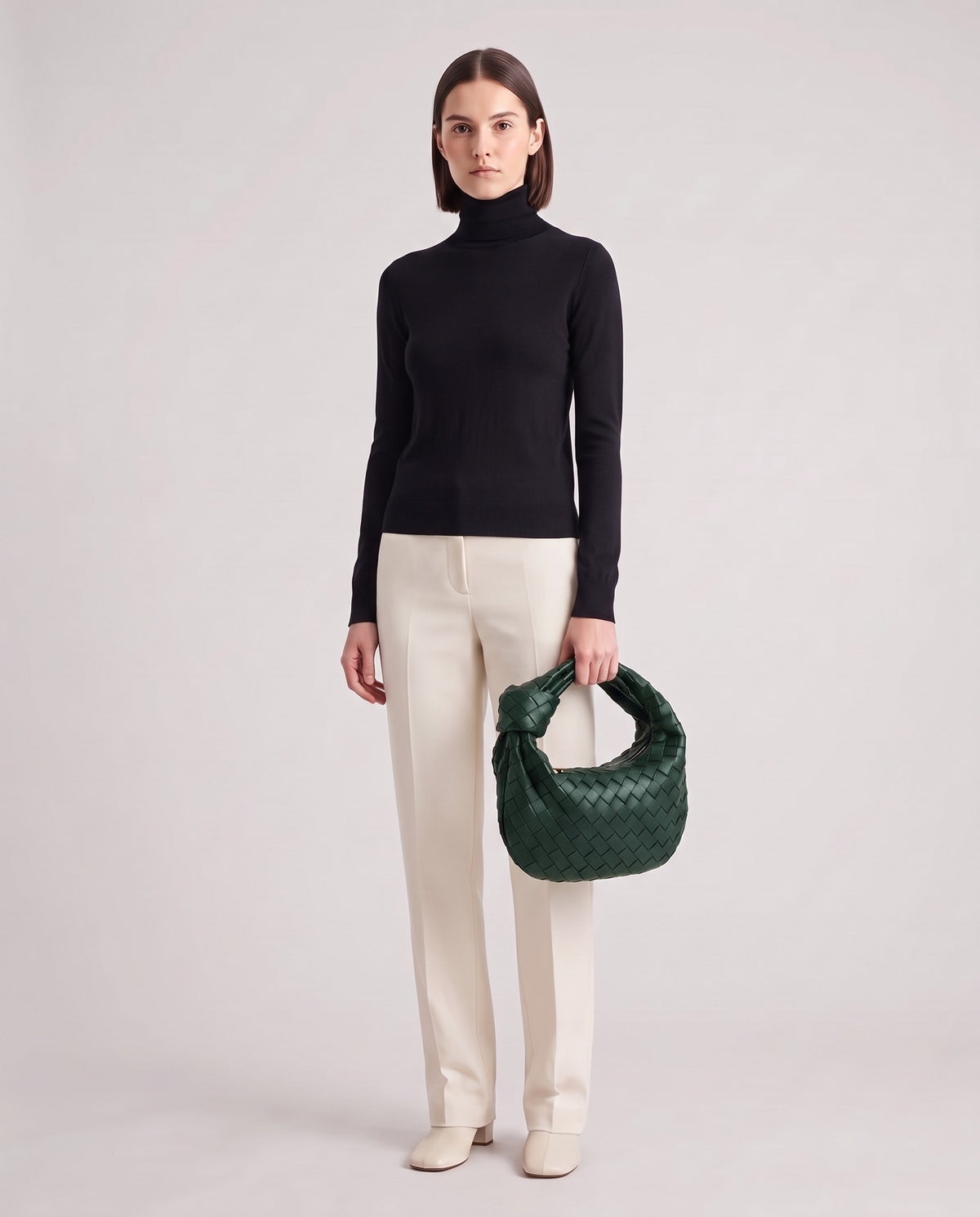 Knot Midi woven leather bag in Forest – model holding it, full length