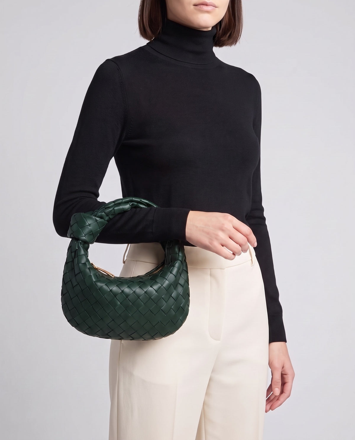 Knot Midi woven leather bag in Forest – model carrying it