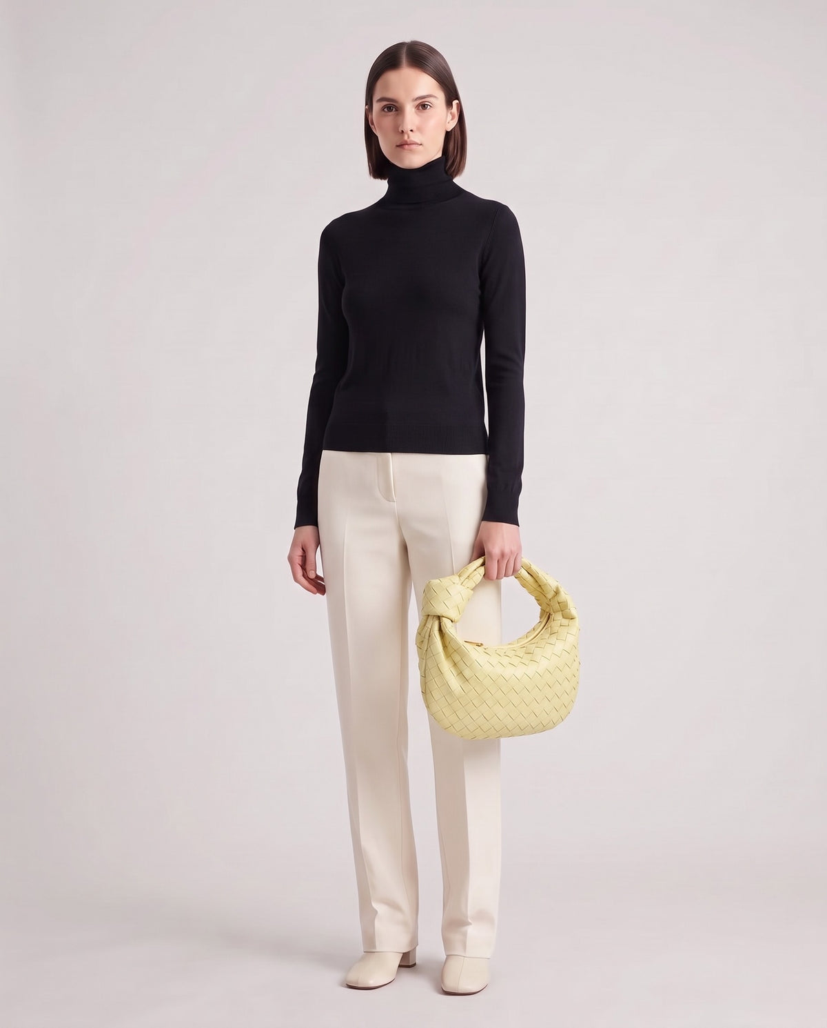 Knot Midi woven leather bag in Yellow – model holding it, full length