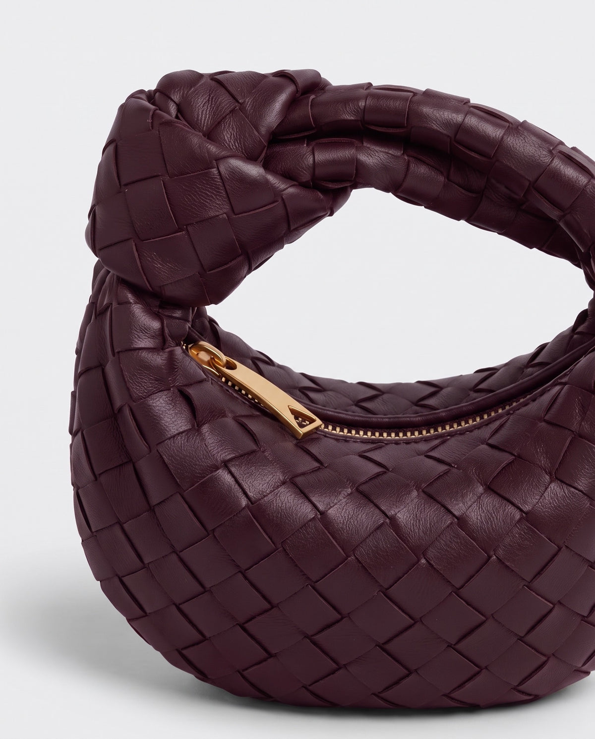 Knot Mini woven leather bag in Bordeaux – close-up of the knotted handle