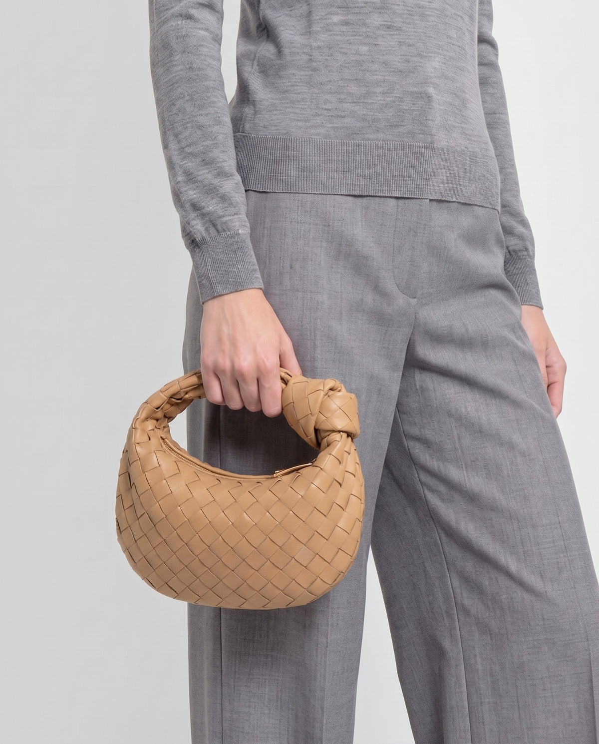 Knot Mini woven leather bag in Camel – model carrying it